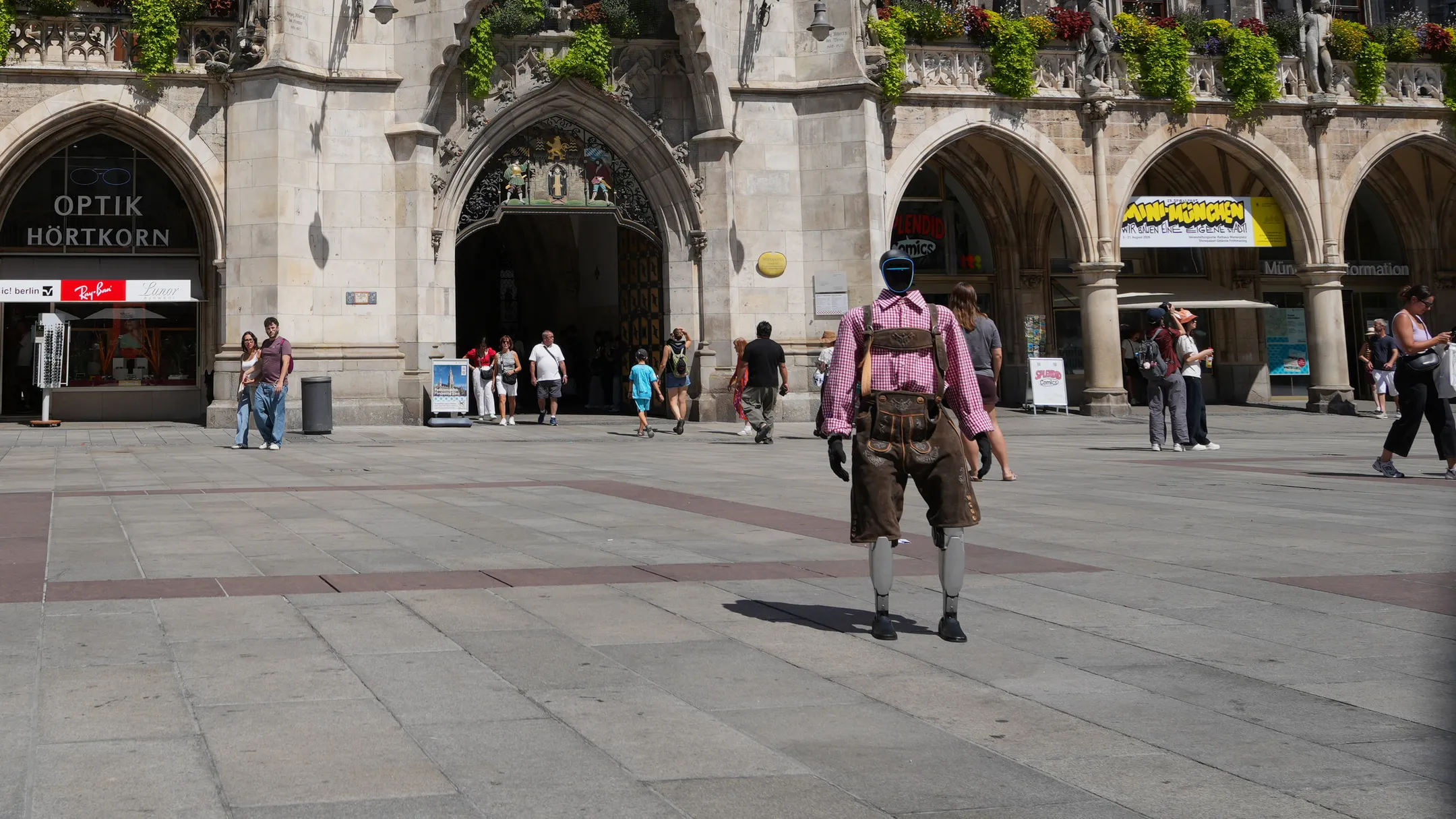 Our humanoid robot in Lederhosen walking across Munich's Marienplatz towards the New Town Hall